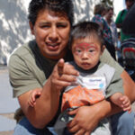 Latino man with young child